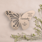 uma lembrança borboleta em bétula com ramos de flores ao lado