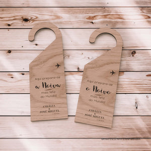 Placas de cabide em madeira com veios naturais, destinadas à noiva e ao noivo. A esquerda anuncia "Aqui prepara-se a Noiva mais feliz do Mundo!" e a direita "Aqui prepara-se o Noivo mais feliz do Mundo!", referindo-se ao casamento de Cidália e José Miguel em 21.09.2024