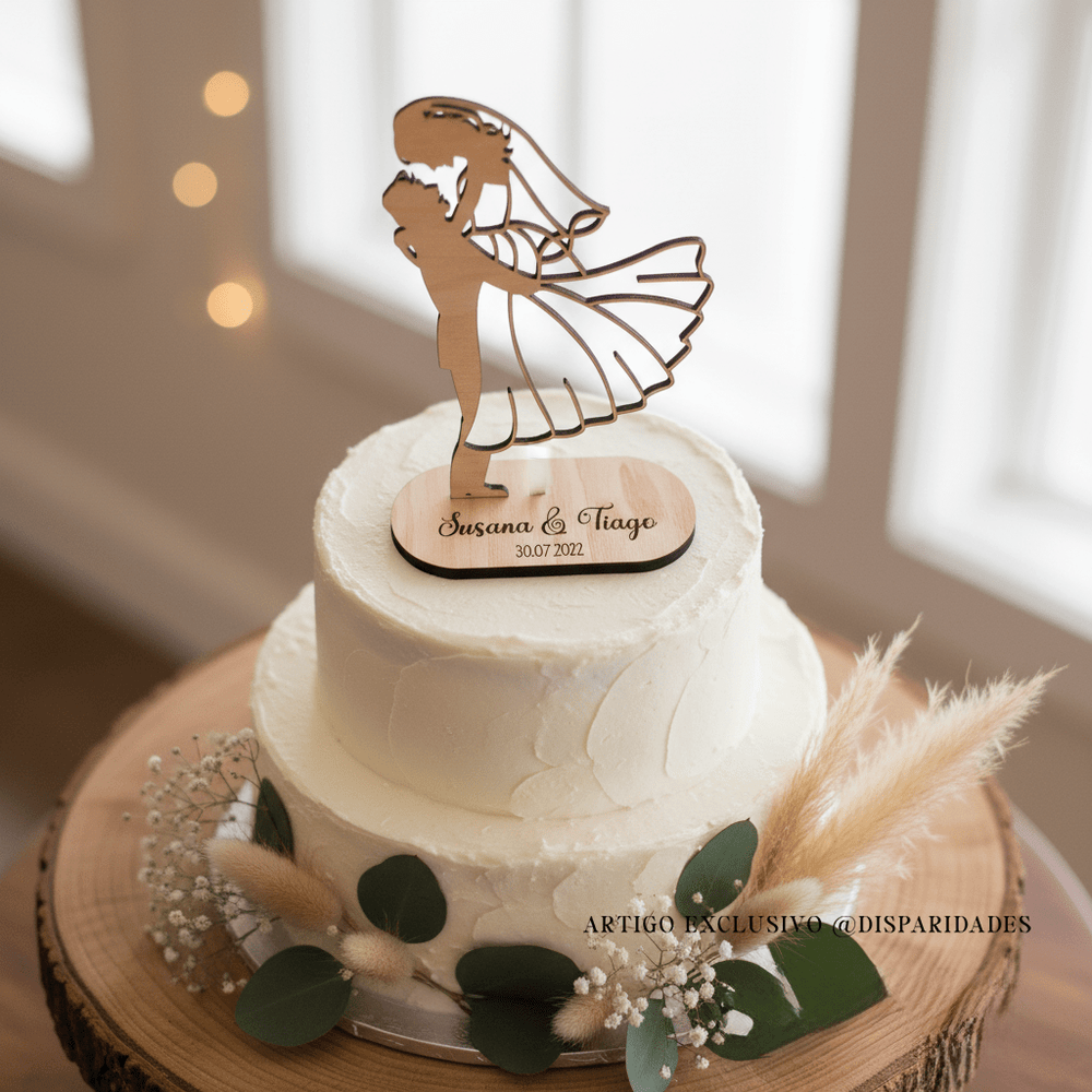 um bolo de casamento com um topo de bolo em madeira com a forma de um casal gravado susana & tiago com a data